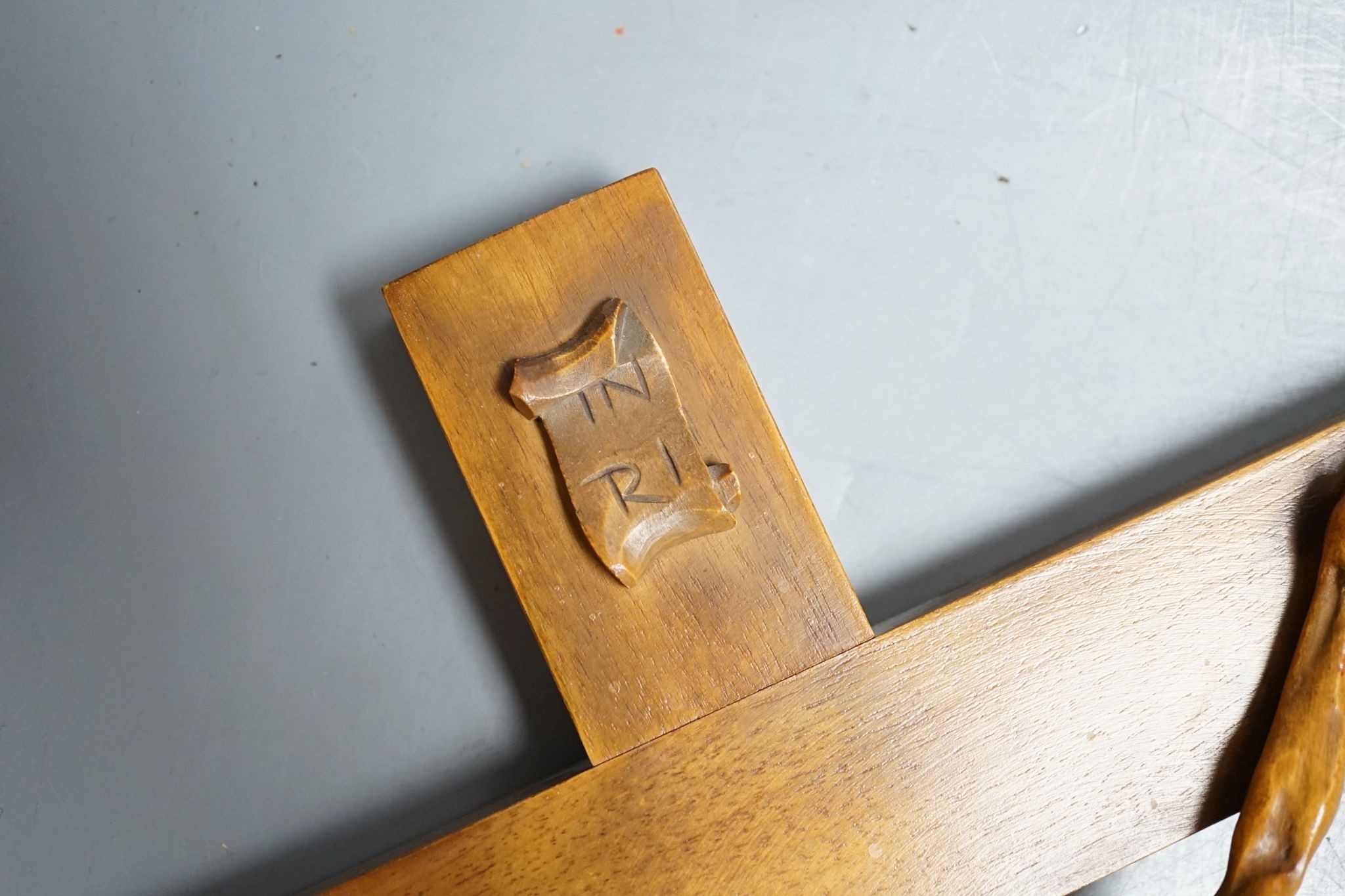 A carved crucifix and a framed metal Peruvian colonial crucifix, 50cm